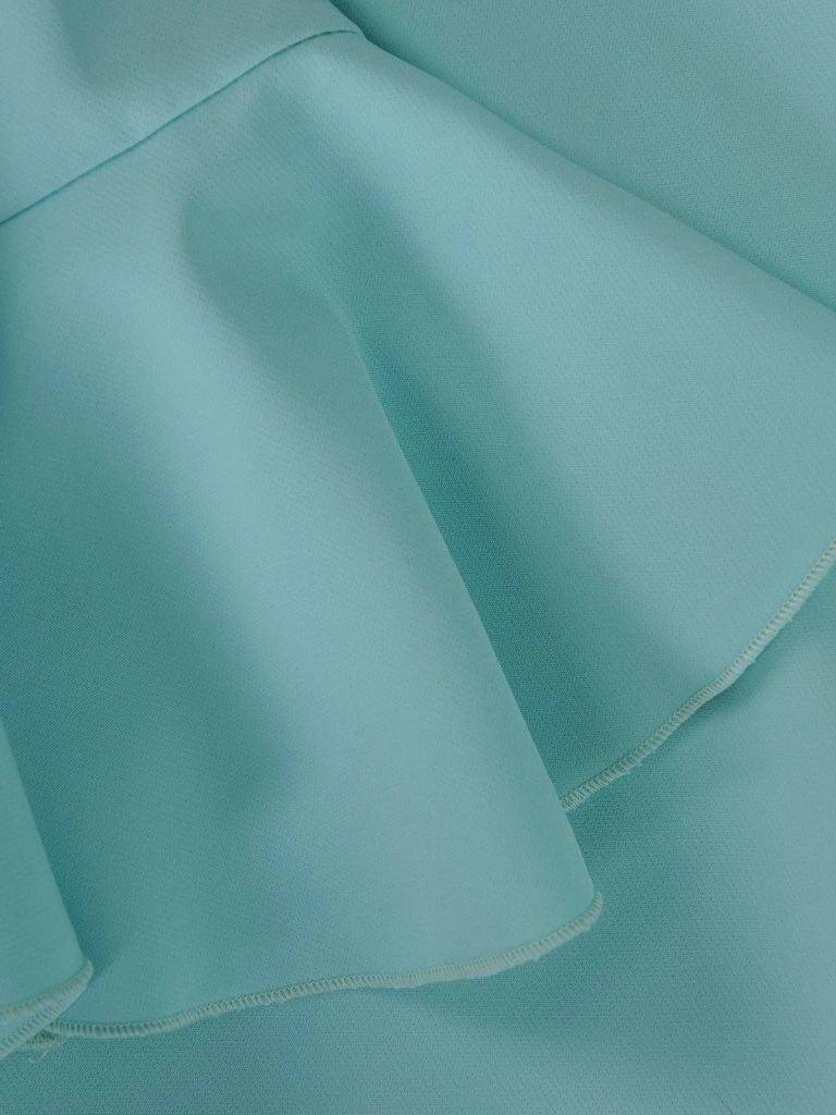 Elegancka sukienka trapezowa w odcieniu mięty – kobiecy krój tuszujący biodra z falbanką 15579