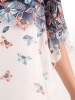 Letnia bluzka plus size w kwiaty z szyfonową narzutką – asymetryczny krój maskujący sylwetkę i dekolt łódka 38528